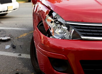 closeup of a car with a smashed in front headlight